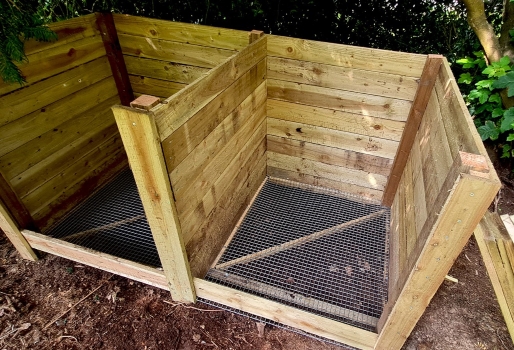 Custom-built, timber compost bins with mesh base.